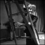 Photograph: [Barbara Bristow standing at ladder]