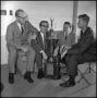 Photograph: [Leon Breeden and others sitting with trophy]