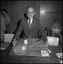 Photograph: [Board of Regents member showing his tennis cake]