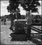Photograph: [Boy standing next to an engine]