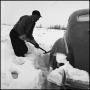 Photograph: [Man shoveling his car out of the snow, 4]