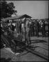 Photograph: [People looking at a small locomotive engine]