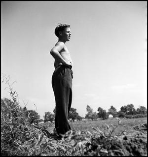 Primary view of object titled '[Boy standing a field]'.