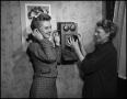 Primary view of [Two women and a wall telephone]