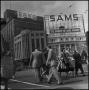 Photograph: [People crossing the street in front of Sams]