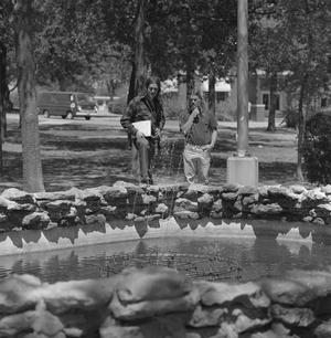 Primary view of [Two UNT students looking at a fountain]