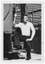 Photograph: [Bill Nelson sitting on metal steps]