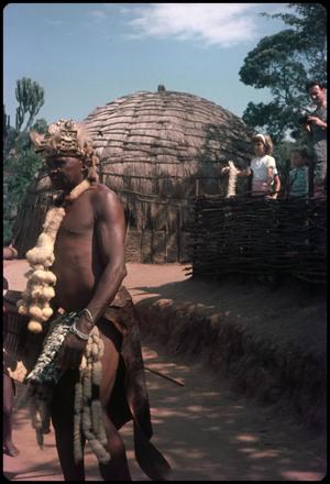 Primary view of object titled 'Zulu man and beehive huts'.
