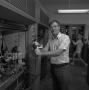 Photograph: [Man standing next to Chemistry lab equipment, 3]