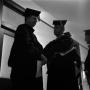 Photograph: [Faculty talking in hallway at commencement 1961]