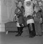 Photograph: [Santa Claus with two kids at a Christmas party]