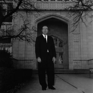 Primary view of object titled '[Dr. Ernest Clifton standing in front of the Auditorium English Building]'.