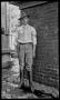 Photograph: [Byrd Williams, Jr. standing outside a darkroom]