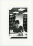 Photograph: [Male student studying in North Texas State University library]