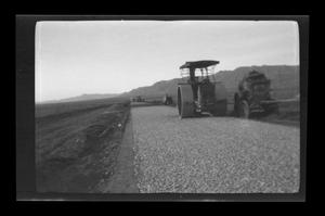Primary view of object titled '[Heavy construction equipment on a desert road]'.