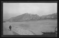 Photograph: [Man walking along the Rhine River across from Ehrenbreitstein Fortre…