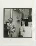 Photograph: [Photograph of man outside Chamber of commerce, 2]