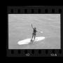 Primary view of [Girl standing on a surfboard at a lake]