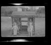 Photograph: [A boy and a girl in a playhouse]