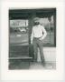 Primary view of [Photograph of man in front of a piano restoration building, 2]
