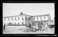 [Man constructing a stone building in front of the Stevenson House in Monterey, California]