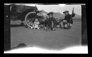 Primary view of object titled '[Irene Williams posing with her children in the desert]'.