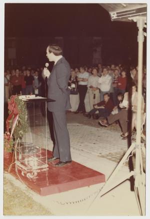 Primary view of object titled '[Don Baker standing in front of podium]'.