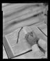 Photograph: [Man with hands on an open Bible]