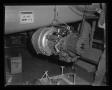 Primary view of [The Lycoming turbine engine being hoisted to the top of XH-40 #1]