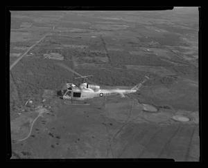 Primary view of object titled '[First flight of XH-40 #3 over the Hurst plant]'.