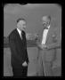 Photograph: [Bart Kelley and Fred Forrer stand and talk on the Hurst heliport]