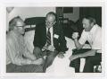 Photograph: [Three Men Seated Together in Room]