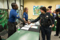 Photograph: [Police officers shake student's hand the LGBTQIA Career Fair, 2]