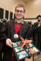Photograph: [Young Man Showing off Graduation Cap]