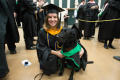 Photograph: [Graduating Student Poses with Dog for Photo]