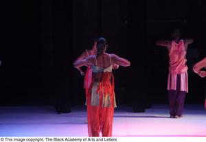 Primary view of [Photograph of four dancers standing on a dark stage]