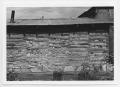 Photograph: [Exterior View of a Stone and Wood Wall]