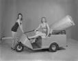 Photograph: [Models with Motorized Cart]