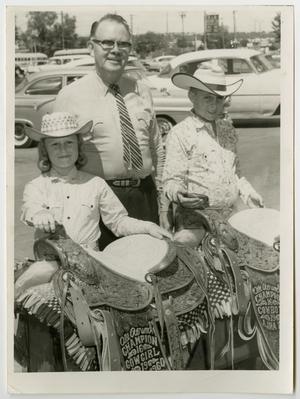 Primary view of object titled '[Photograph of Bill Myres with two children]'.