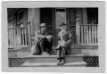 Photograph: [Two Unidentified Men Sitting on a Porch]
