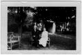 Photograph: [Unidentified Couple Sitting in a Yard]