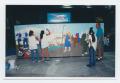 Photograph: [Three Students and Mural]