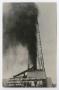 Primary view of [Oil Blowing over an Oil Derrick ]