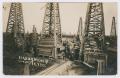 Postcard: [Photograph of a Group of Oil Rigs]