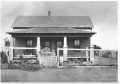 Photograph: [One story wood house with front porch]