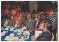 Photograph: Mona and Milt Hinton in group at table