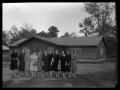Photograph: [Women in Front of Log Cabin]