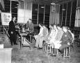 Photograph: [Roy McCormick, far left, lectures Tech-voc class at the Oldsmobile f…