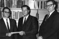 Photograph: E.D. Redding, Dr. Richard D. Strahan, J.P. Davenport receive a check …