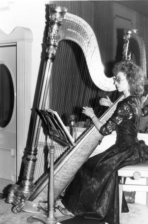 Primary view of object titled 'Bonnie Goodrich playing harp at Lee College Gala honoring Fred Hartman'.